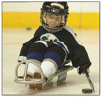 Dylan get's into position for some stick handling | Tampa Bay Times Forum | Sled Hockey